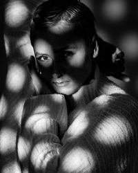 Close-up of young woman with graphic shadows