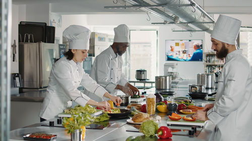 Team of kitchen professionals preparing food