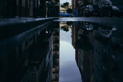 Reflection of buildings in puddle