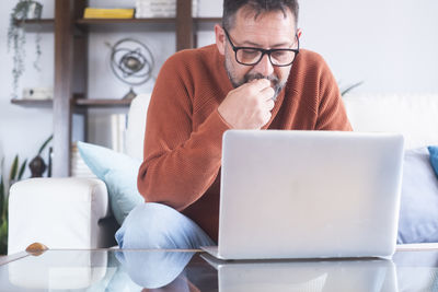 Man using laptop at home