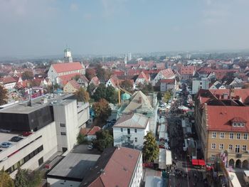 High angle view of illuminated buildings in town against sky