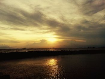 Scenic view of sea against cloudy sky