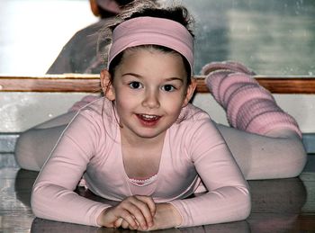 Portrait of happy ballet dancer lying on floor