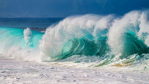 High resolution photo of waves crashing against the shore