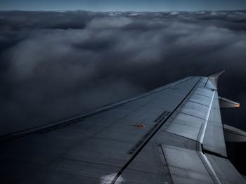 Airplane flying over cloudscape against sky