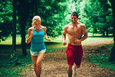 Full length of a man running in forest