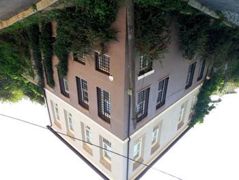 House by trees against sky