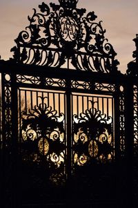 Close-up of metal gate against building