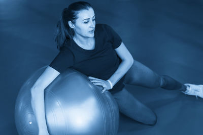 Young woman exercising in gym
