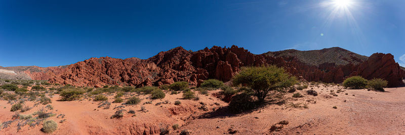 Scenic view of desert against blue sky