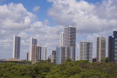 Buildings in city against sky