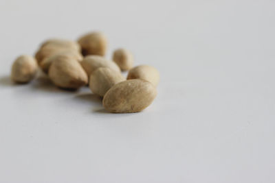 Close-up of bread on table against white background