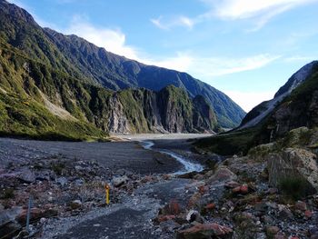 Scenic view of river amidst mountains against sky