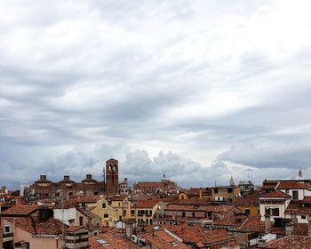 Buildings in town against sky