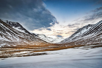 Scenic view of landscape and mountains against sky during sunset