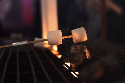 Close-up of burning candles on barbecue grill