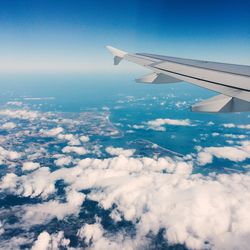 Cropped image of airplane wing over landscape