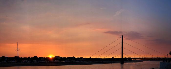 Silhouette bridge against sky during sunset