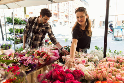 Couple choosing flowers at market