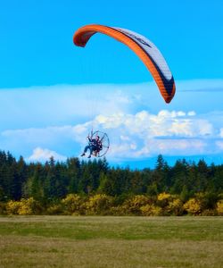 Hot air balloons flying over landscape