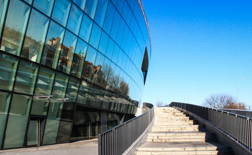 View of footbridge against blue sky