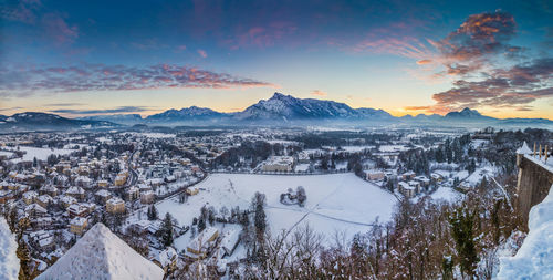 Scenic view of snow covered mountains against sky during sunset