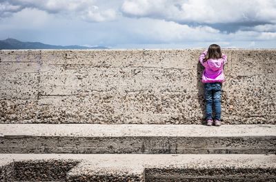 Full length of woman standing against sky