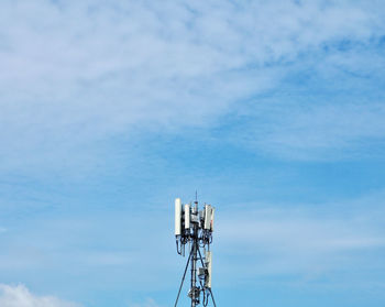 Low angle view of communications tower against sky