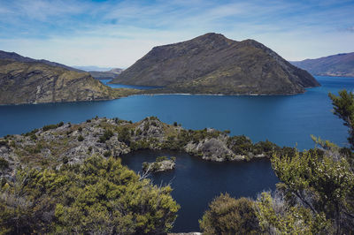 Scenic view of lake and mountains against sky