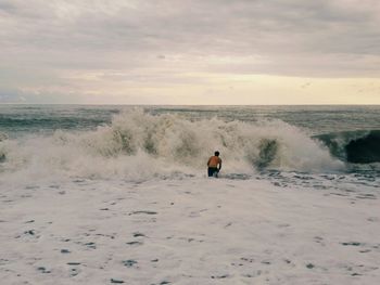 Rear view of a man swimming in the sea