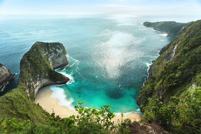 High angle view of sea and rocks against sky