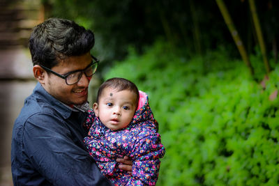 Close-up of father holding baby daughter