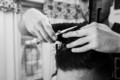 Barber cutting hair of man in the barber shop