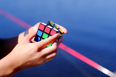 Close-up of hands playing with puzzle cube