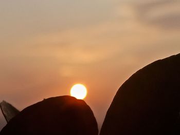 Scenic view of silhouette mountains against sky during sunset