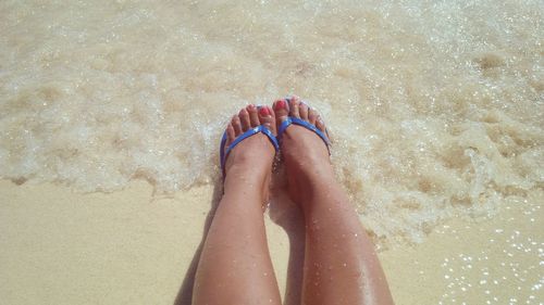 Low section of legs on sand