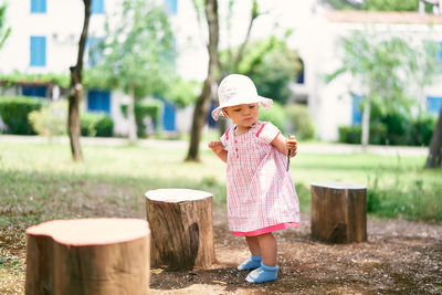 Full length of cute girl wearing hat standing at park