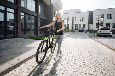 Side view of man riding bicycle on street