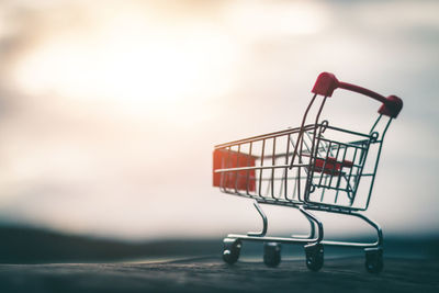Close-up of empty deck chairs against store