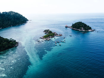 High angle view of sea and rocks against sky