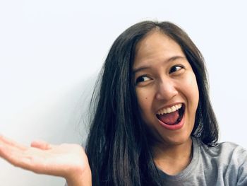 Portrait of a beautiful young woman over white background