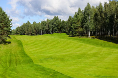 Scenic view of golf course against sky