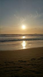 Scenic view of beach against sky during sunset