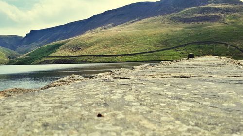 Scenic view of river amidst mountains against sky