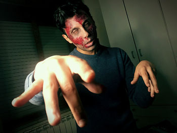 Young man standing against wall