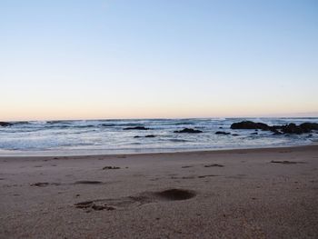 Scenic view of beach against clear sky