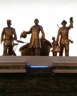 Low angle view of statues against clear sky