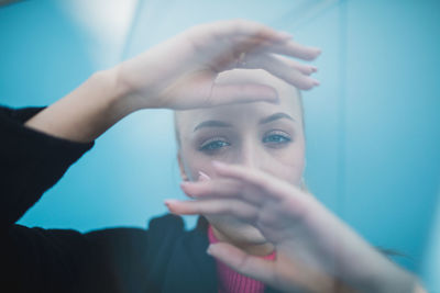 Portrait of woman holding hands