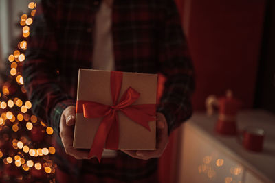 Man holding christmas decoration in box