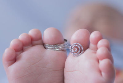 Close-up of rings on baby barefoot